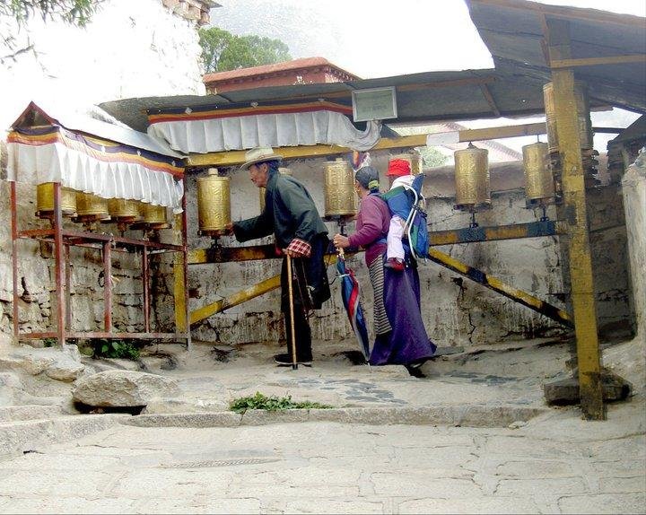 Lhasa family spinning prayer wheels. Another of my favorite pics from this trip.