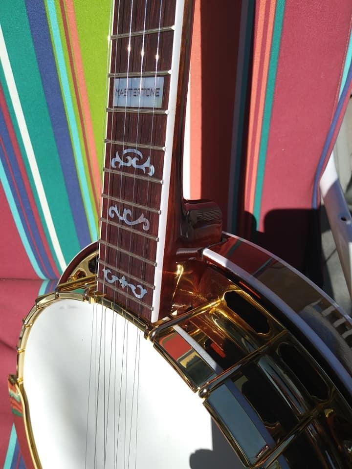 Closeup of neck/pot, showing the nice neck fit, wreath inlays and gold hardware. Very sweet-looking banjo!!