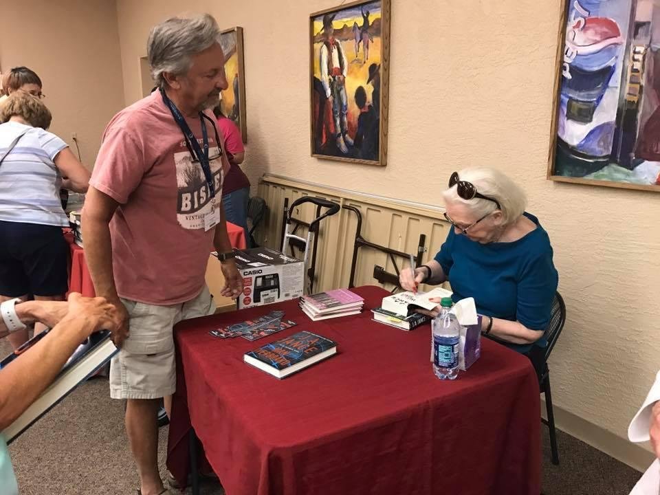 geo with his bisbee shirt on getting his book signed by favorite author