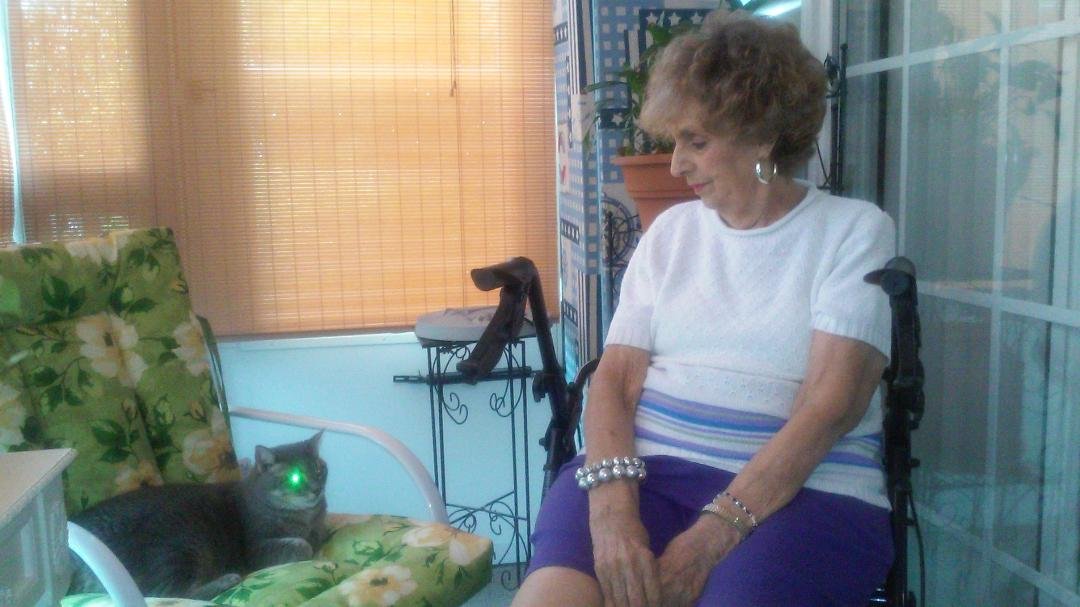 Llinda and her Cat named Peba on our screened in porch.