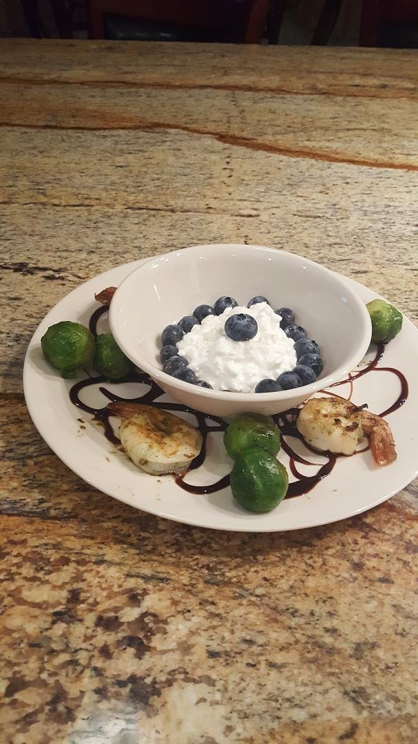 My shrimp with grilled brusselsptouts, cottage cheese & blueberries. Balsamic glaze on the plate . Learning to take care of myself.