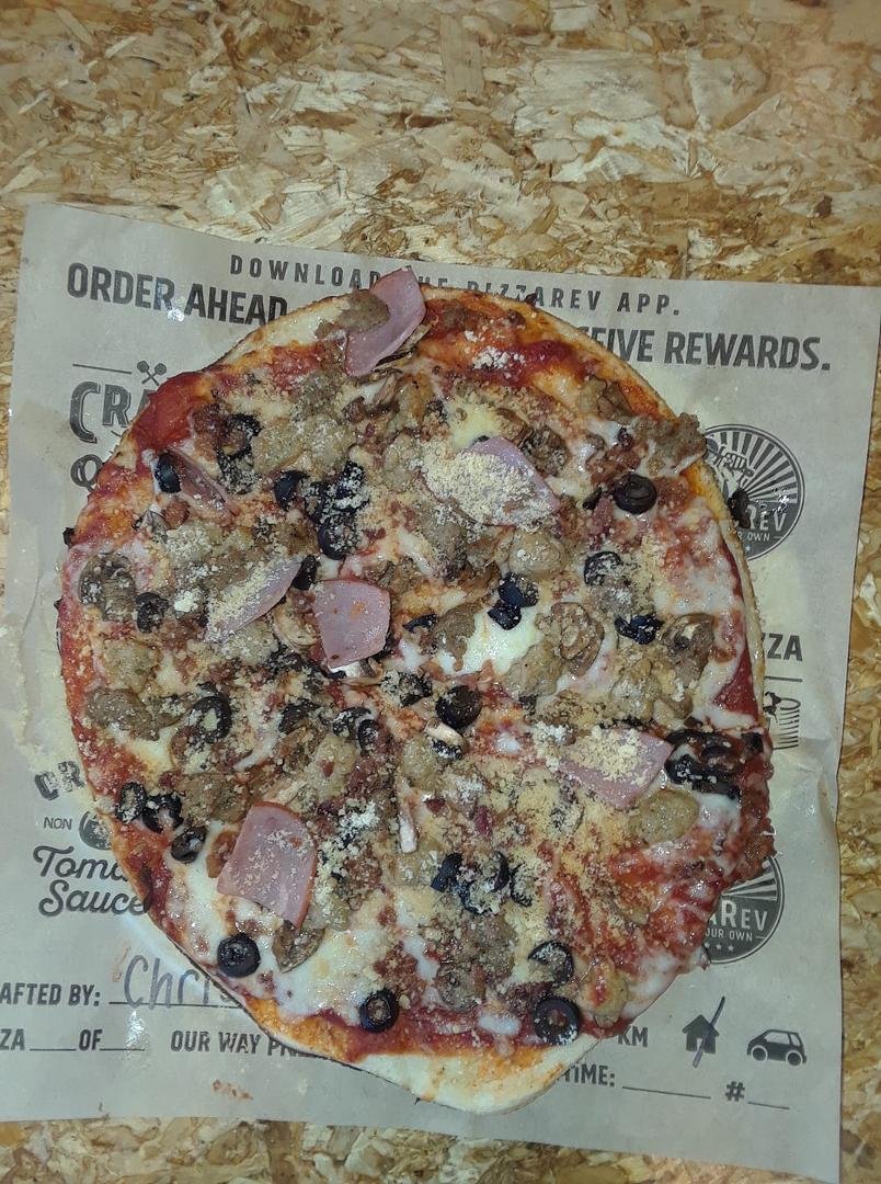 Enjoying free pizza for Janice's upcoming birthday.