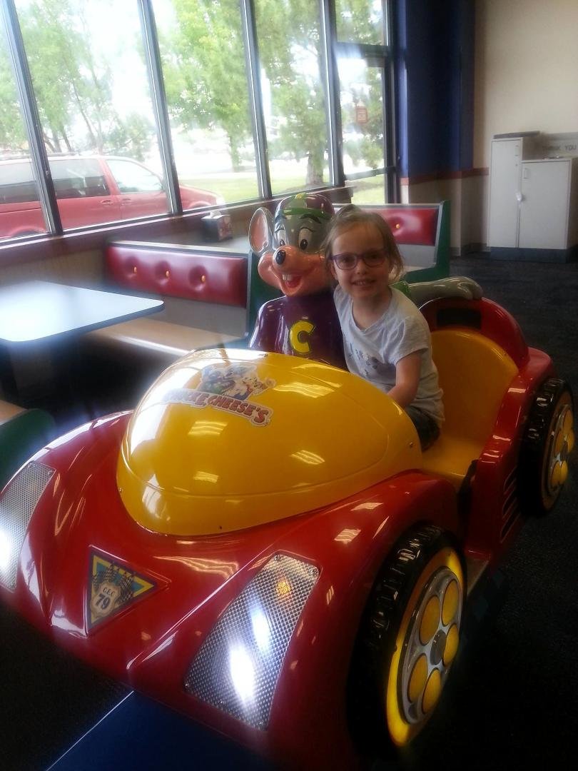 Brooklyn, my niece, riding a ride at Chuck E. Cheese