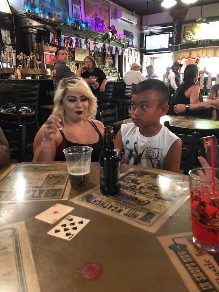 Our grandson meets a saloon girl and takes a shot with her. LOL