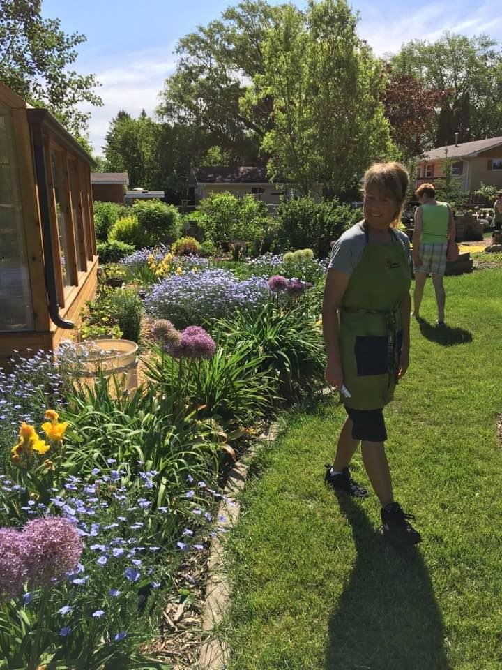 Stephanie Aas shows me around a yard in Aberdeen SD, where a plant sale was being held.