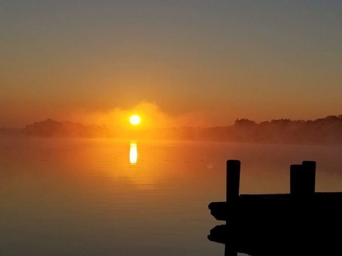 Sunrise on Pewaukee Lake by Rose Schlimgen.