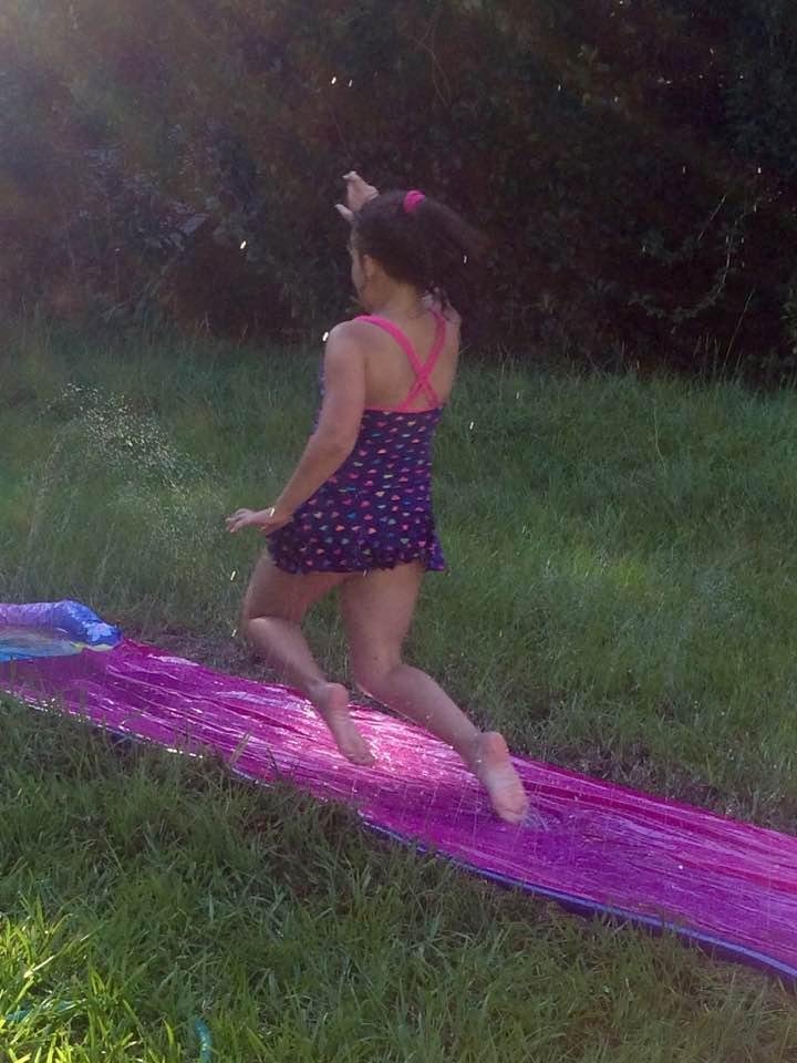 Ava airborne on the slip n slide! Children may be sore in am and sl bruised but I can tell they had a blast!!!