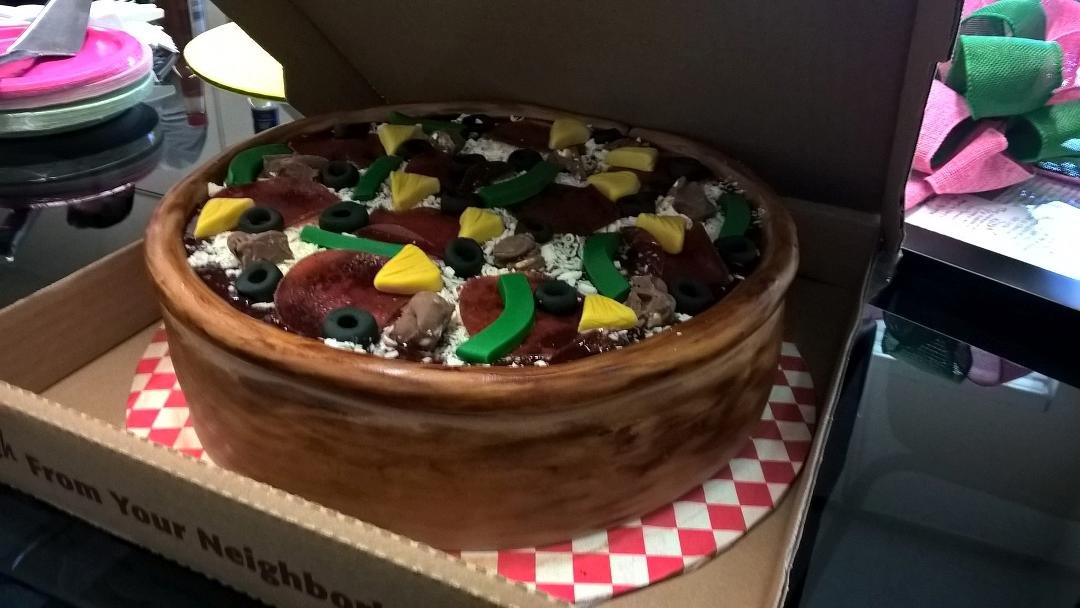 A cake shaped like a pizza. I am at a loss for words.