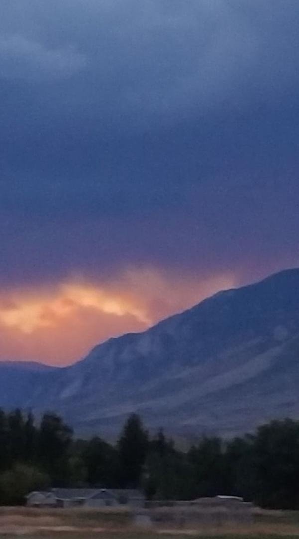 A hole in the cloud, showing the sun set over sheep Mt at Cody WY