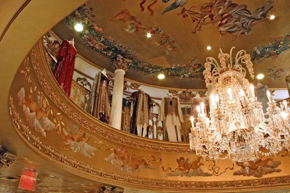 More naked children encircling a dazzling chandelier.