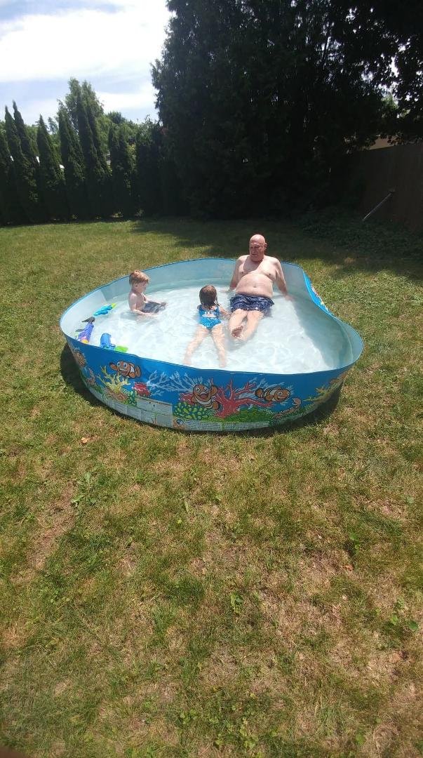 Grandpa in the pool with grandaughter ANA,and grandson ALEX .