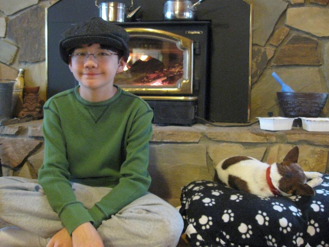 Skylar warming near the fire after playing Mandolin and fiddle. His trusted side kick, Rocky (lazy Dog) wouldnt even smile for the camera.