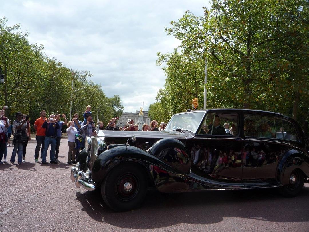 Although it is not easy to see inside, this car is transporting Prince Charles and Camilla to the VJ Day Activities near the Abbey. We just happened to be at the right place at the right time to catch this. They were wavi