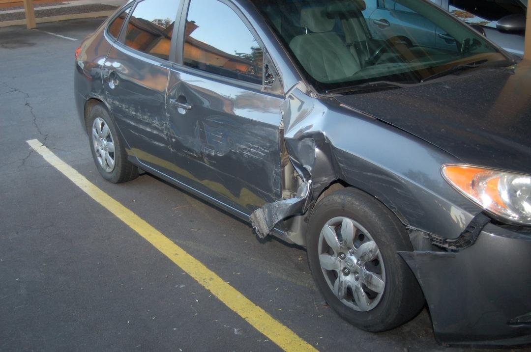Tom's car after he was sideswiped while he was stopped at a traffic light.  The teen driver of the other car tried to go between Tom's car and the car in the right lane.  Car's future in hands of insurance company now.  Tom