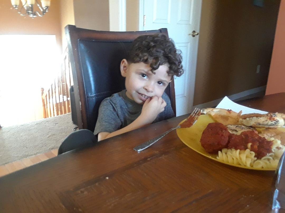 Cayden getting ready to eat his monster meat ball