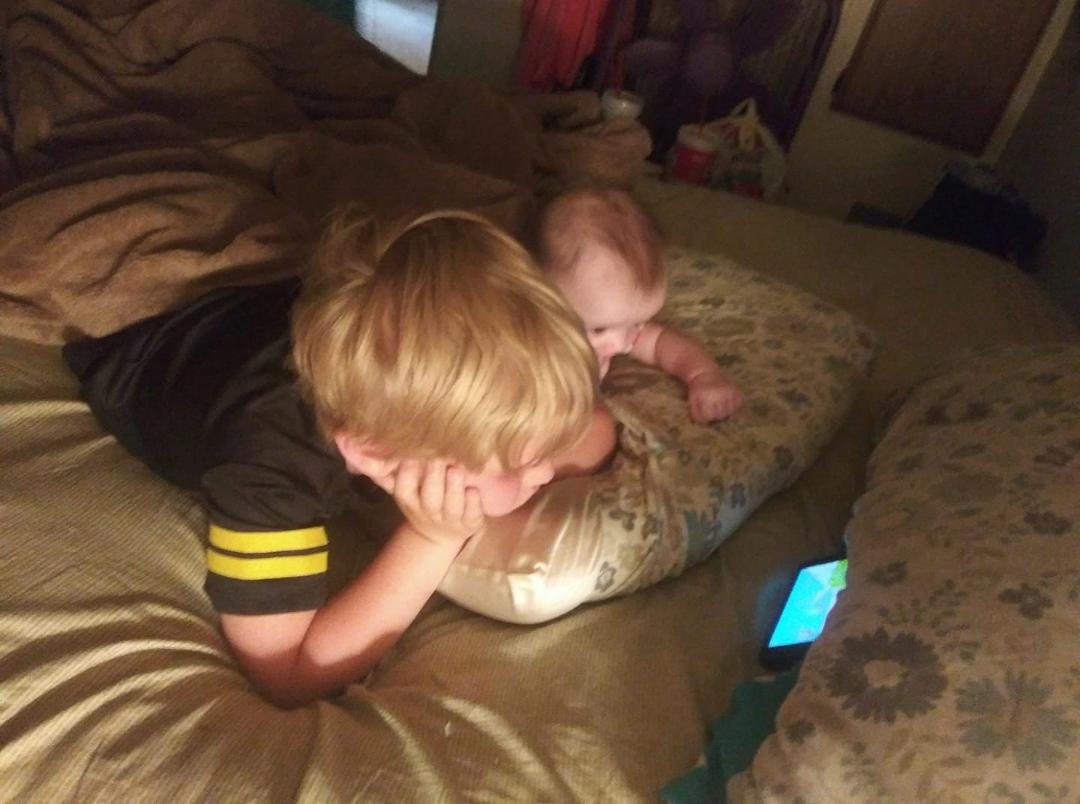 Big brother watching cartoons with lil sis!