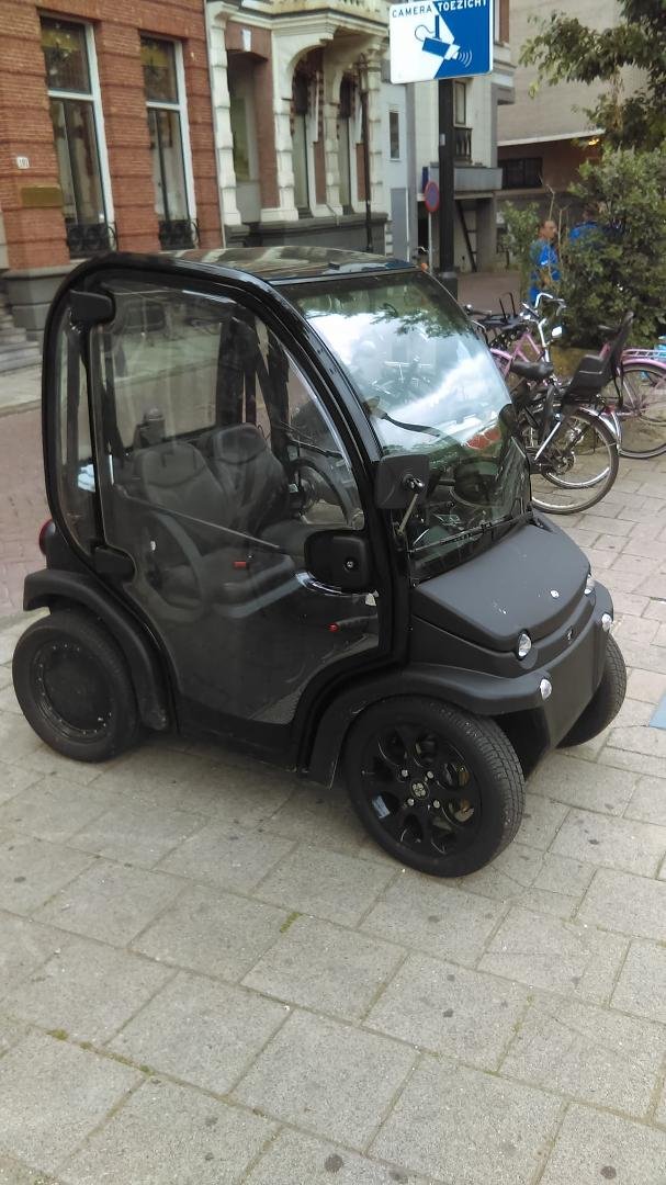 Saw this tiny car in Amsterdam - parked next to the bicycles.
