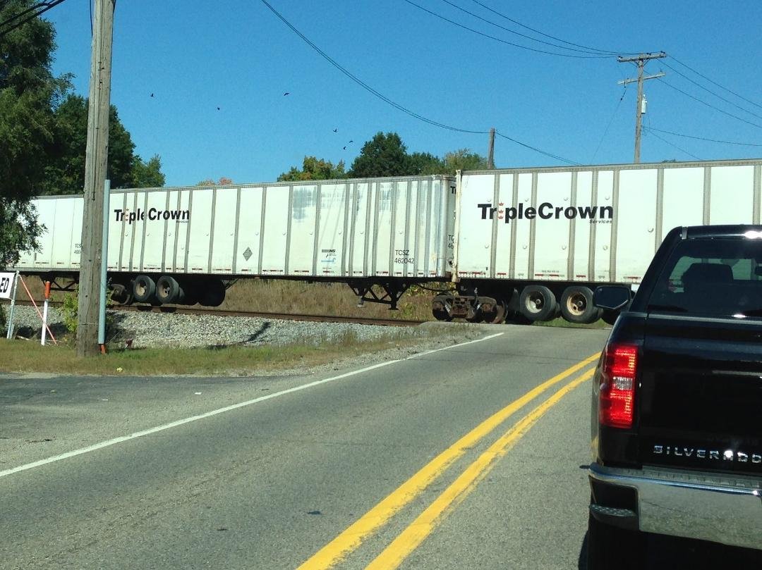 This was a first for me today, a train of semi-trailers connected together with set of railroad wheels in between each trailer. I hadn't seen this before. Cool.
