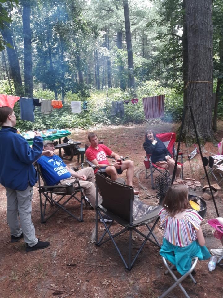 Sitting around the campfire in between showers. Supper on the grill