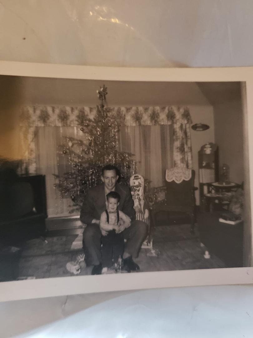 My dad and I Christmas 1959. When I was 7, I started to doubt in Santa Claus existence. I set out the requisite milk and cookies and wrote a note asking for Rudolph's hoof print. Excitedly I ran to the living room the nex