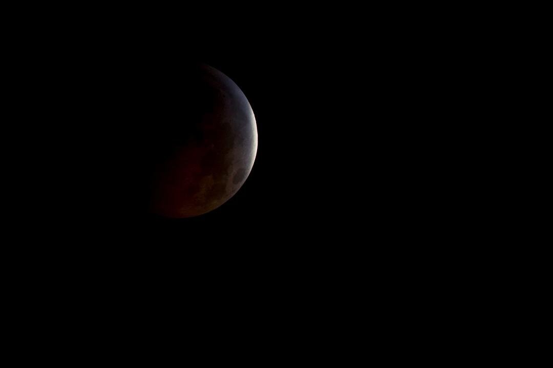 A nearly total lunar eclipse is seen as the full moon is shadowed by the Earth on the arrival of the winter solstice, Tuesday, December 21, 2010 in Arlington, VA. From beginning to end, the eclipse will last about three ho