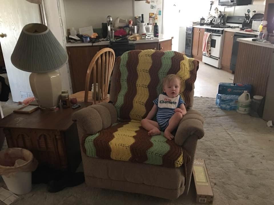 Handsome boy in big boy chair looking proud
