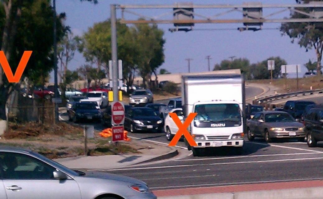 The V marks a wood fence in FOOD4LESS lot where a CHP hides to peek thru and give tickets to people at the X who don't see the NO RIGHT TURN ON RED tiny sign. These people are just coming off freeway 110. CHP is the State