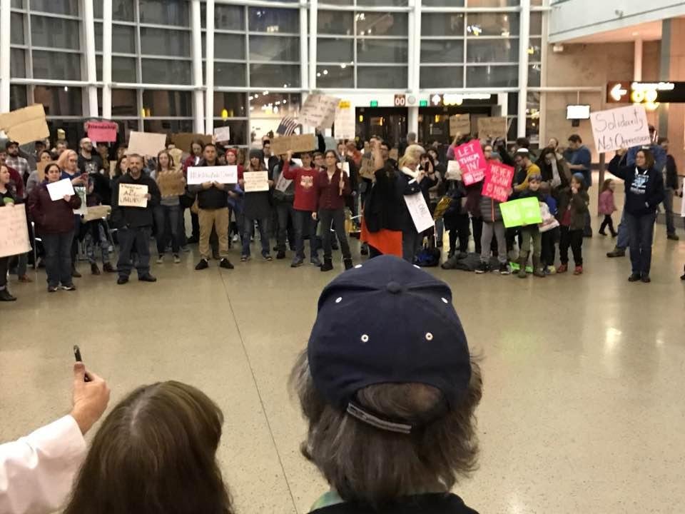 Growing crowd at SeaTac protesting Trump's immigrant ban. Glad to join the outrage.