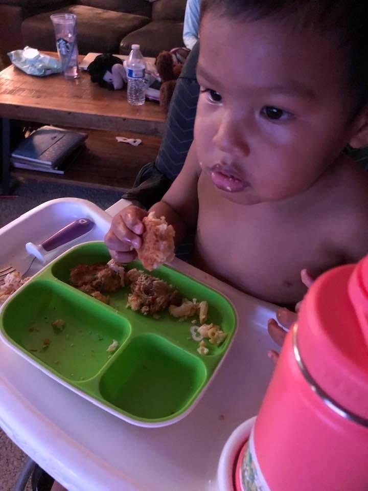 Enjoying Gammy Mac and cheese and crab cakes with his biscuit!