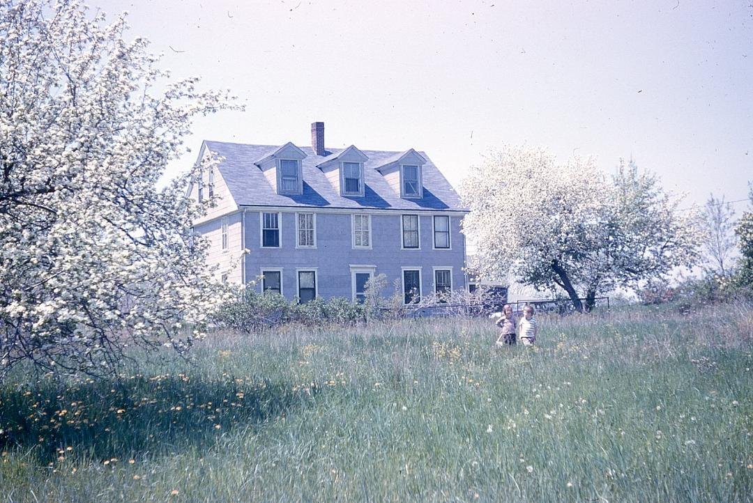With my sister Mary in front of old farmhouse at 440 Allen Avenue North Attleboro, MA where us 6 kids grew up. Built in late 1700 s as  we were told. Torn down early 1980 s but interior still exists in my mind.