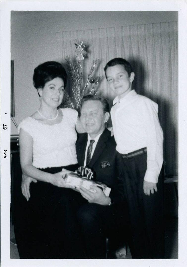 A  couple months after our first year in California. Mom on dad's lap and me looking too proud - must have got some kind of grown-up gift : )  For fellow "Boomers" note the aluminum tree, popular back then with the frugal c