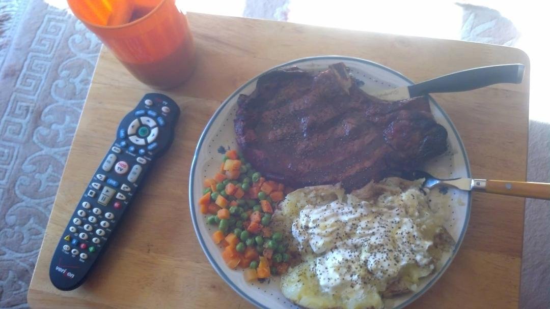 Let's see...rib-eye steak..check....baked potato with sour cream...check...peas and carrots...check....remote control...hell yeah.
I am all set......