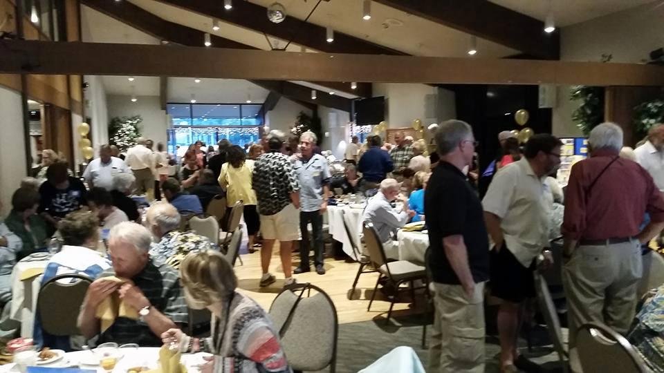 Enjoying old friendships at class reunion.