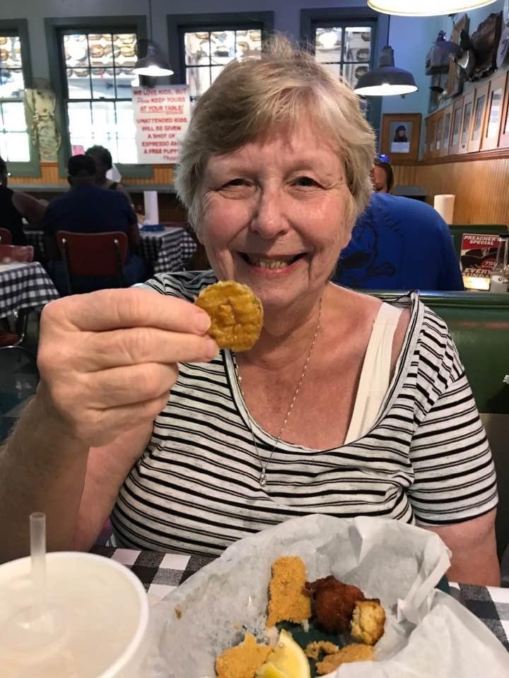 Judy sampling fried dill pickles at the Flying Fish in Memphis