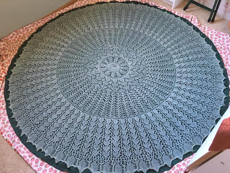 My Pi shawl is finished and being blocked on the sewing room floor. It ended up blocking to just under 60" in diameter.