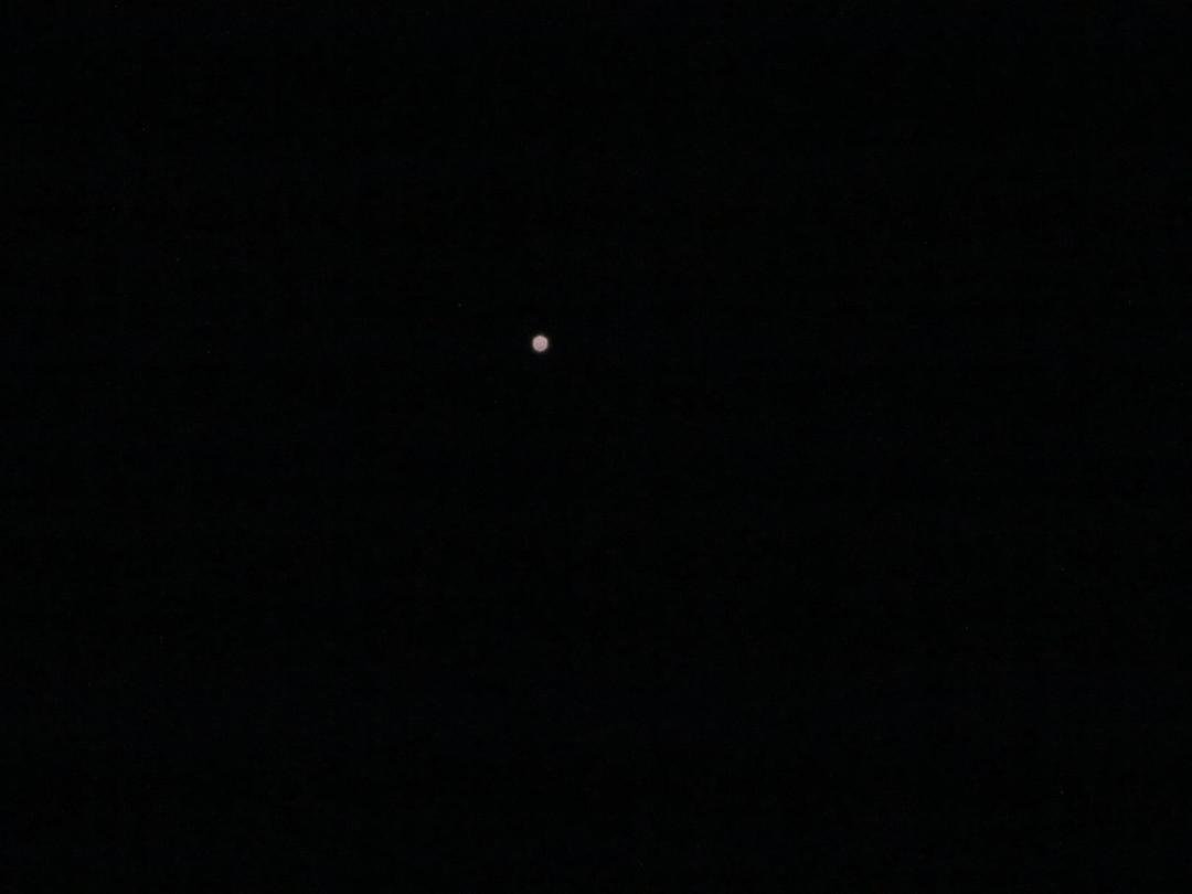 This is a photo of Jupiter. With a telescope, you can see three of its moons. The camera I have just won't pick them up. I'm going to need better equipment!