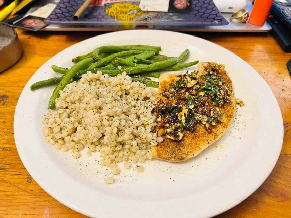 Tilapia filet with an almond parsley lemon gremolata and couscous with green beans.