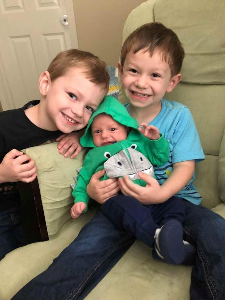 Our four year old twins with their new baby brother. What good boys.