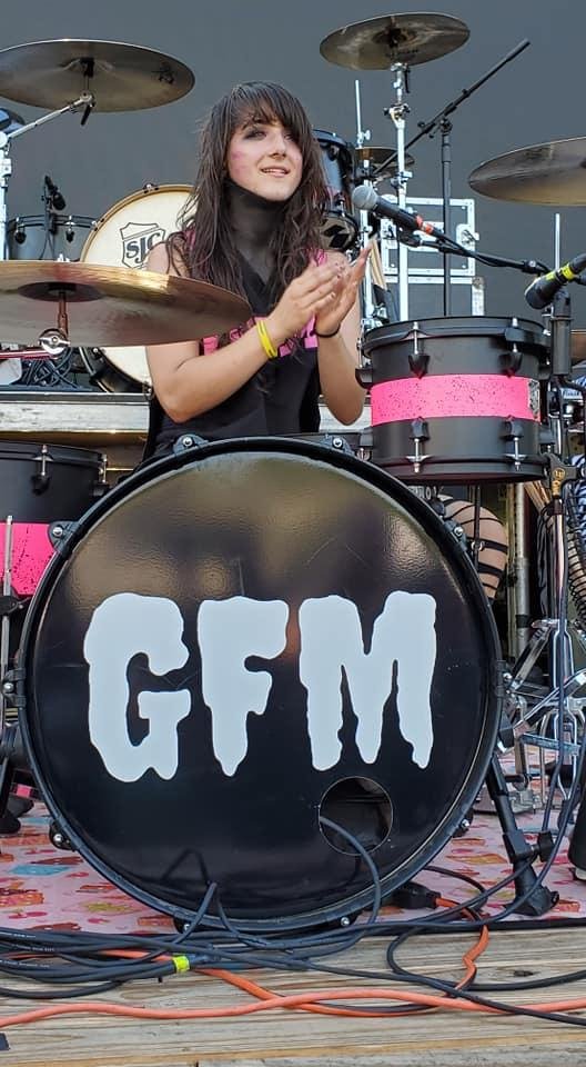 Lulu plays drums.