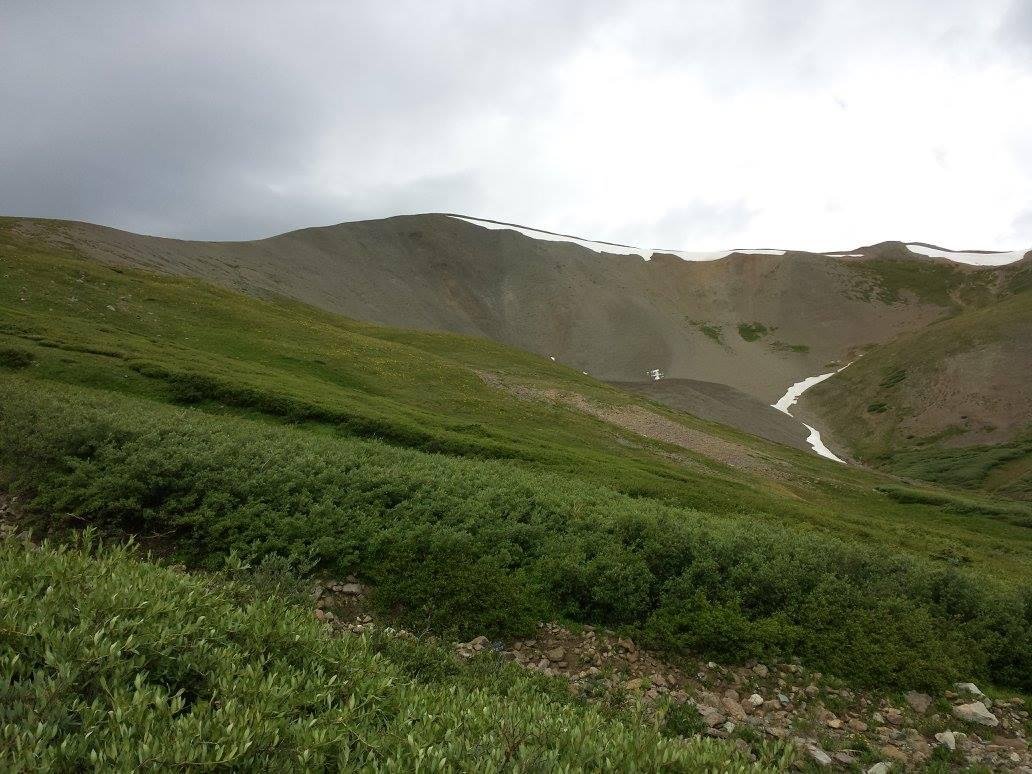 Closer to the mountain at the end of the valley.