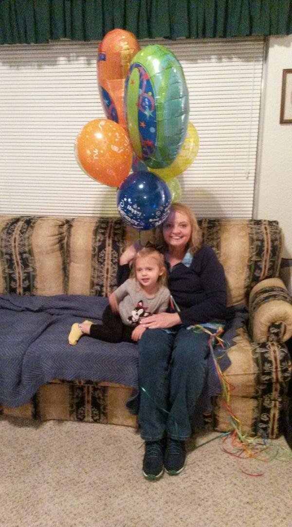 Isla and Karen celebrate "Grandma's birthday" under Isla's "umbrella."