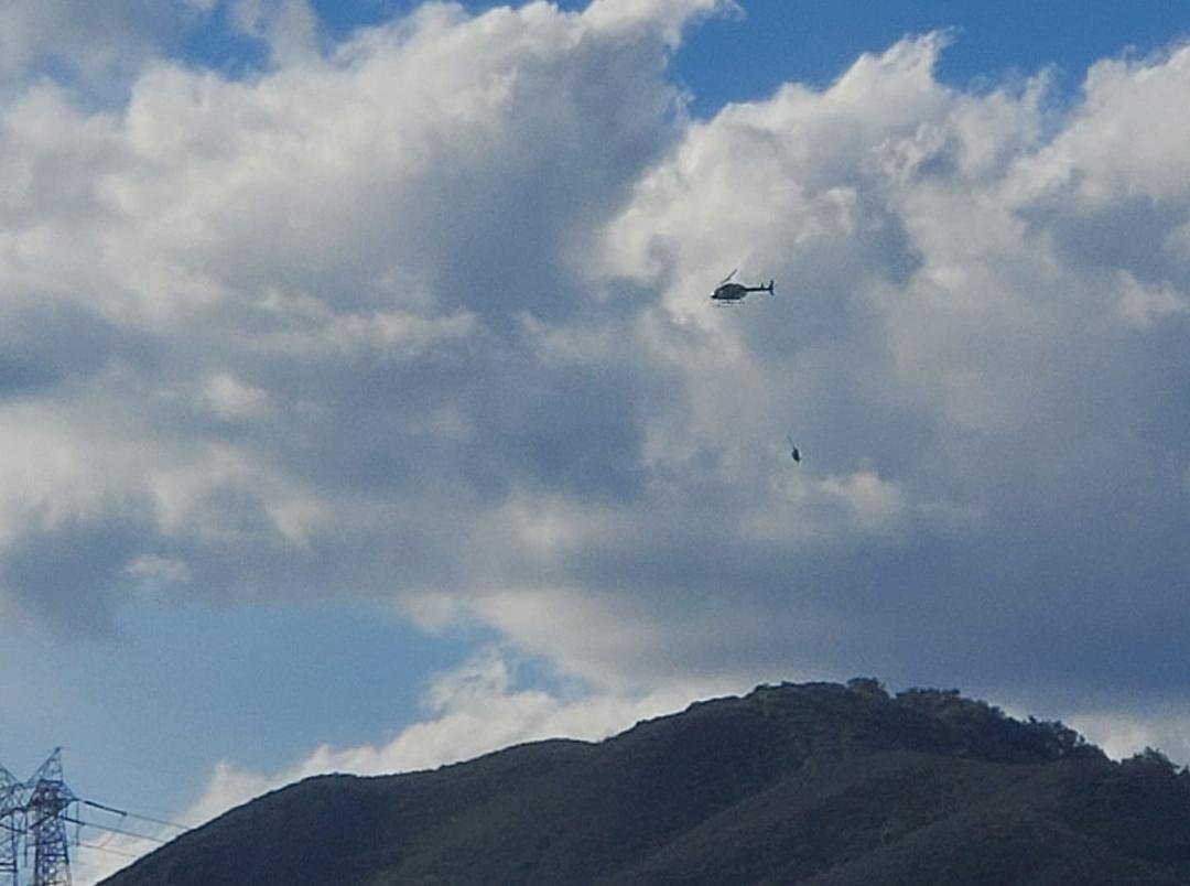 That is 2 men .. PG&E .. dangling from that copter hook!! What a ride!! Heh Pamela Louise Fulmer!!