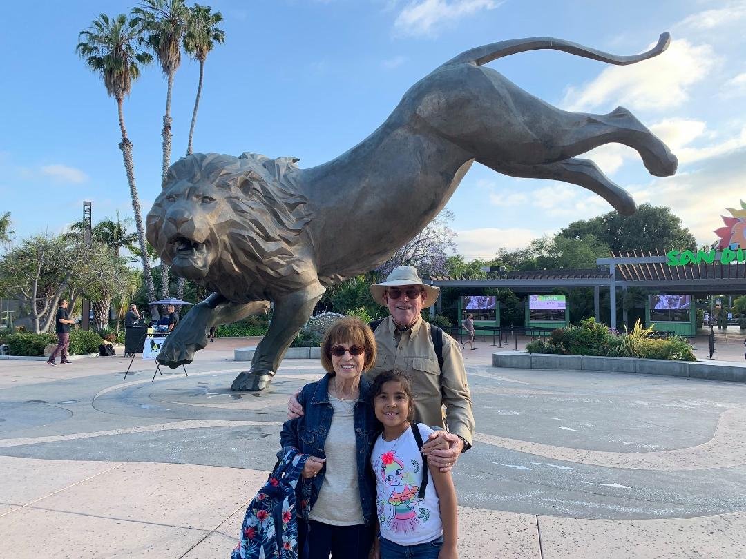 Grandma & Grandpa Larson with Sisilia at the entrance to the San Diego Zoo.
