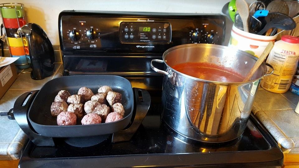 Getting ready to put the meatballs into the sauce.