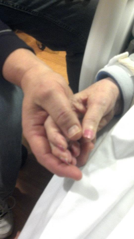 My mother and me, holding hands in her final days.