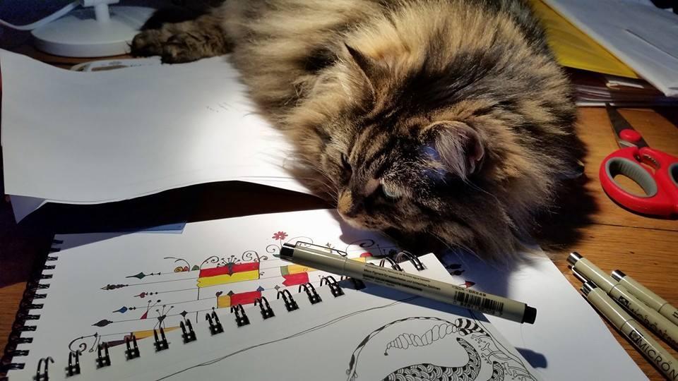 Sometimes you just need to be right in the middle of things..
Jude needed some attention, so she decided to get in the middle of my drawing time today by lying on my sketch pads and grabbing for my pen each time I reached f