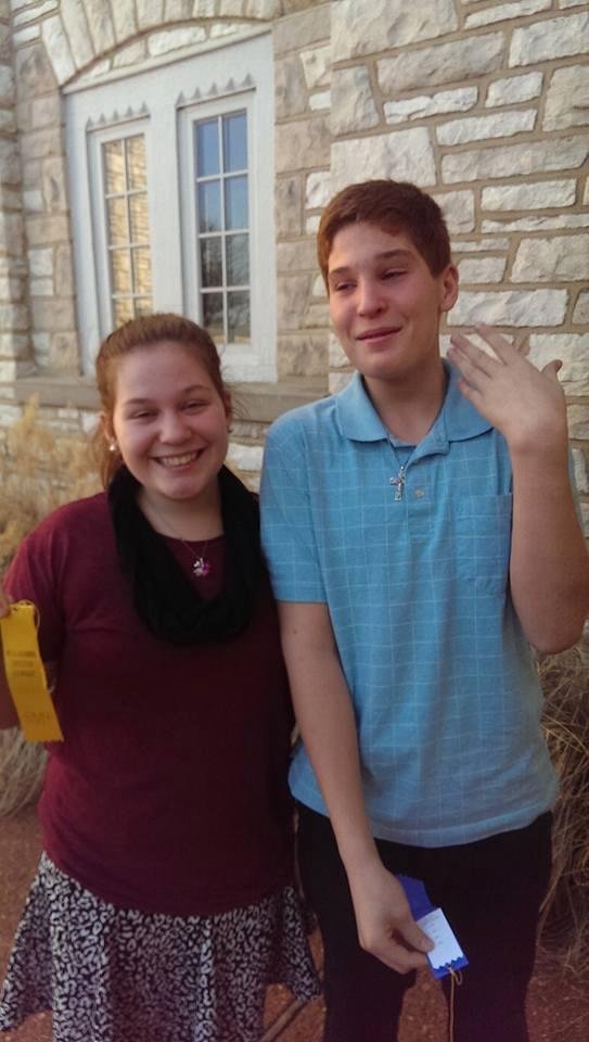 Marisa and Blake after Speech contest. Marisa wins the gold ribbon  and Blake wins the blue ribbon.  Blake trying to look like he was crying tears of joy. So proud of my grandchildren.