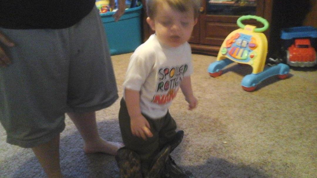 Wearing daddy's boots