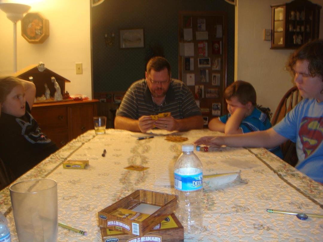 Grand kids play cards with their Dad
waiting for the New Year to ring in.
