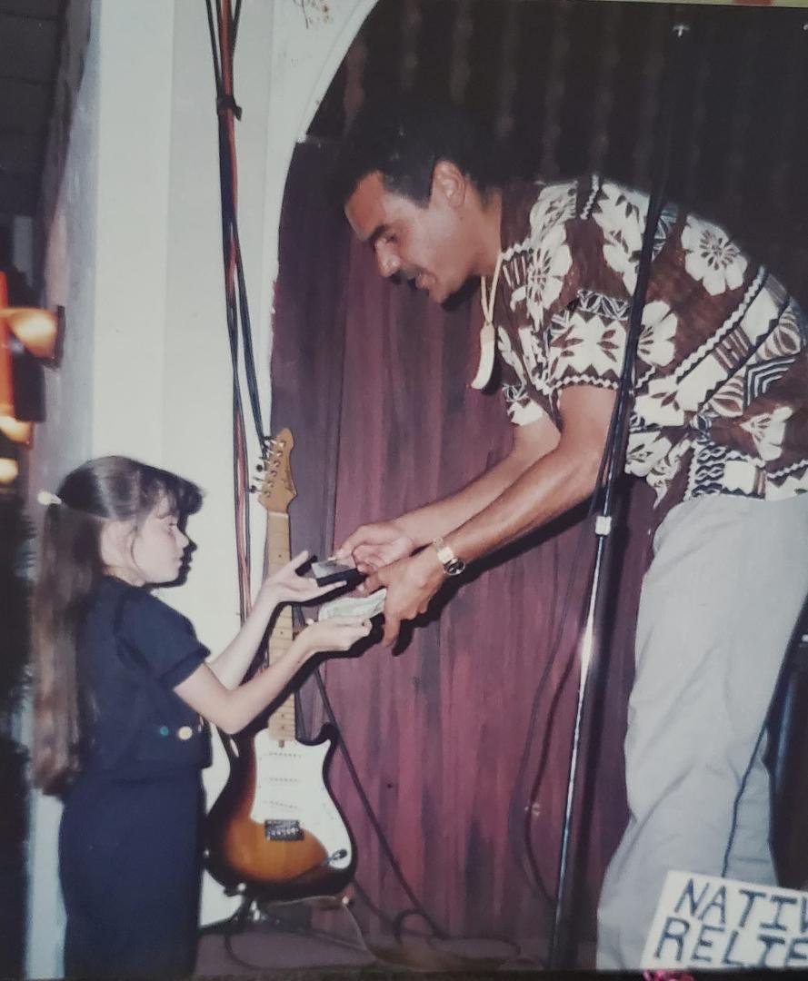 Ok story time: This picture is me being sent up to the band to buy their tape. I didn't want to go. The "stage" was across a crowed BAR somewhere in Hawaii. My mom thought it would be funny to send a "kid" up there. Didn't 